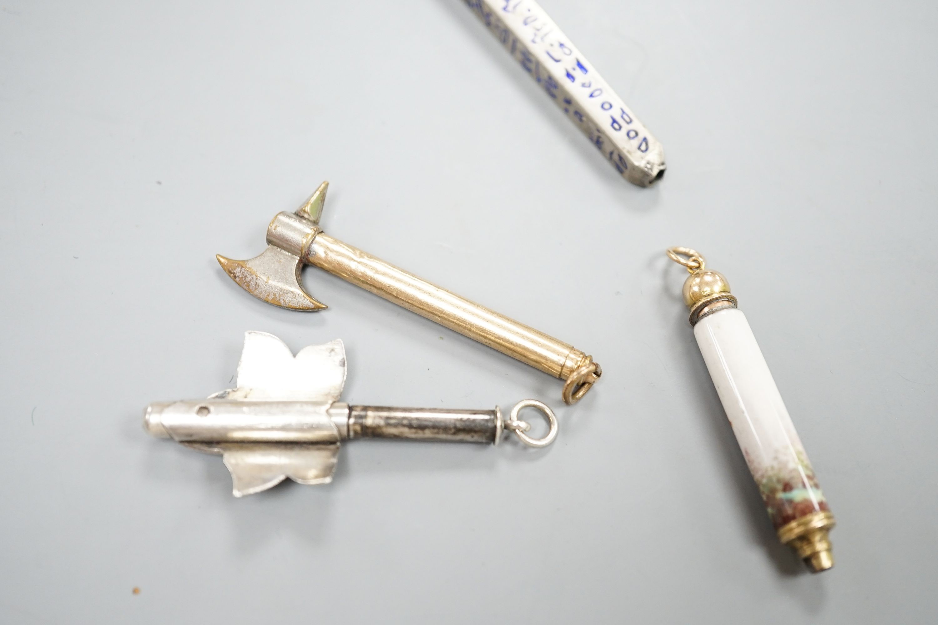 Four assorted pencils, including three enamelled and novelty modelled as an axe